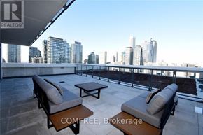 Toronto (Church-Yonge Corridor) condo for rent - A balcony with two chairs and a table is set up on a rooftop.