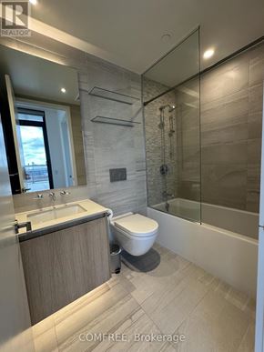 Toronto (Church-Yonge Corridor) condo for rent - A modern bathroom with a glass shower stall and a toilet.