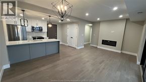 Kingsville condo for rent - A spacious kitchen with a refrigerator, stove, and cabinets.