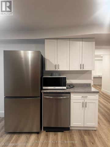 London North (North S) other for rent - A modern kitchen with a stainless steel refrigerator and white cabinets.