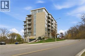 Hamilton condo for rent - A tall apartment building with a parking lot in front.