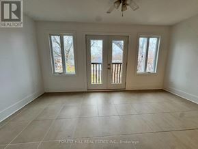 Toronto (Annex) house for rent - A spacious room with a ceiling fan and three windows.