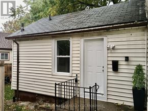 St. Catharines (Downtown) house for rent - A small white house with a black metal fence.