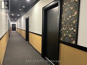 St. Thomas multi-family for rent - A hallway with doors on both sides and a wallpapered wall on the right.
