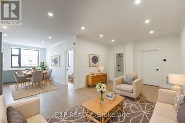 St. Thomas multi-family for rent - A well-lit, spacious living room with a dining area in the background.