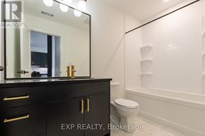 St. Thomas multi-family for rent - A bathroom with a black vanity and a white toilet.