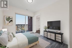 Hanover condo for rent - A bedroom with a bed, a television, and a window overlooking a balcony.