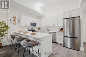 Hanover condo for rent - A kitchen with white cabinets and a stainless steel refrigerator.