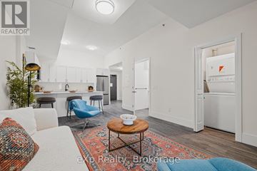 Hanover condo for rent - A living room with a white couch and a blue chair.