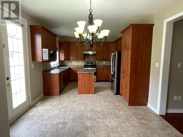 Markham (Wismer) house for rent - A kitchen with wooden cabinets and a tiled floor.