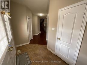 Markham (Wismer) house for rent - A hallway with a white door and a brown floor.