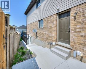 Kitchener house for rent - A house with a grey front door and a small garden area.