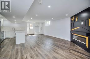 Kitchener house for rent - A modern living room with a fireplace and wooden flooring.