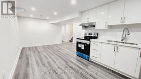 Mississauga (Fairview) house for rent - A kitchen with white cabinets and a blue dishwasher.