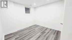 Mississauga (Fairview) house for rent - A room with a wooden floor and white walls, with a window and a door.