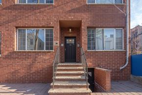 Jersey City apartment for rent - the front of a brick house with stairs and a black door