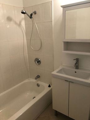 Jersey City apartment for rent - a white bathroom with a tub and a sink