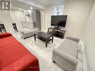 Ajax (Northwest Ajax) house for rent - A living room with a red couch and a television.