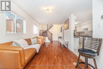 Vaughan (Maple) house for rent - A living room with a brown leather couch and a wooden floor.
