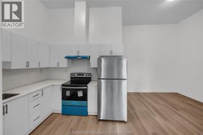 Dresden apartment for rent - A kitchen with white cabinets and a stainless steel refrigerator.