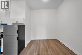 Dresden apartment for rent - A kitchen with a refrigerator and wooden flooring.