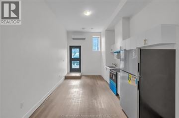 Dresden apartment for rent - A kitchen with a refrigerator and a countertop with a blue container on it.
