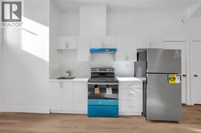Dresden apartment for rent - A kitchen with white cabinets and a blue dishwasher.