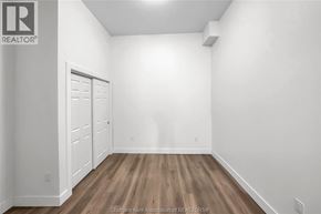 Dresden apartment for rent - A white room with a wooden floor and a door on the left.