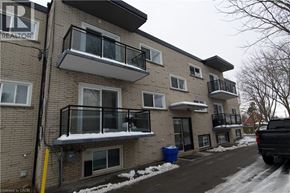 Kitchener apartment for rent - A building with a balcony and a sign that says "REALTOR".