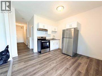 Hamilton apartment for rent - A kitchen with a refrigerator, oven, and microwave.