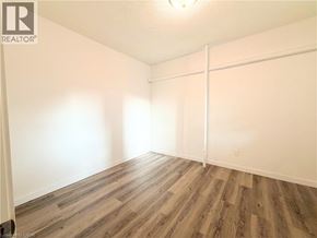 Hamilton apartment for rent - A room with wooden flooring and white walls.