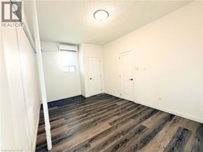 Hamilton apartment for rent - A room with wooden flooring and white walls.