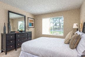 Chino Hills apartment for rent - a bedroom with a bed and a dresser and a mirror