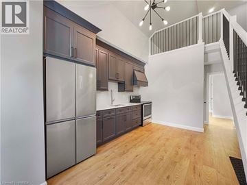 Woodstock house for rent - A kitchen with wooden floors and a stainless steel refrigerator.