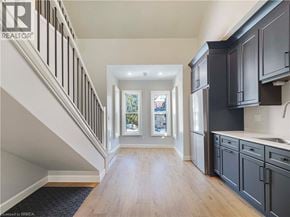 Woodstock house for rent - A spacious hallway with wooden floors and a staircase with white railings.