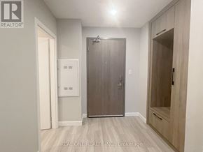 Hamilton (Central) condo for rent - A brokerage office with a wooden floor and a grey door.