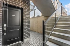 Niagara Falls (Arad/Fallsview) townhouse for rent - A black door with a glass window and a handle is on a brick wall.