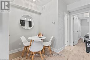 Niagara Falls (Arad/Fallsview) townhouse for rent - A dining room with a white table and chairs.