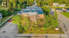For rent in Grande Prairie - A house with a tree in front of it.