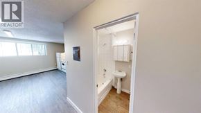 For rent in Grande Prairie - A bathroom with a toilet, sink, and bathtub is shown.