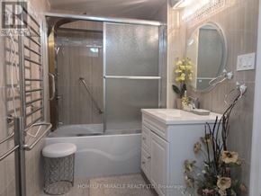 Oakville (Mo Morrison) house for rent - A bathroom with a glass shower door and a white vanity.
