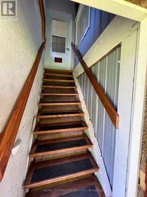 For rent in Tudor And Cashel (Tudor Ward) - A set of stairs leading to a door with a sign on the bottom.