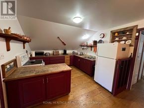 For rent in Tudor And Cashel (Tudor Ward) - A kitchen with wooden floors and marble countertops.
