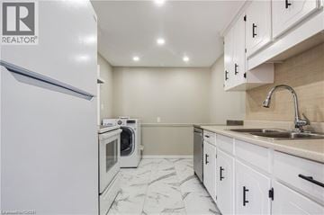 Thorold house for rent - A kitchen with a white refrigerator and marble countertops.