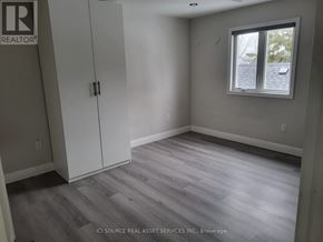 Niagara Falls (Dorchester) house for rent - A white toilet in a bathroom with a glass shower door.