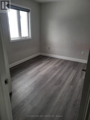 Niagara Falls (Dorchester) house for rent - A room with a window and wooden flooring.