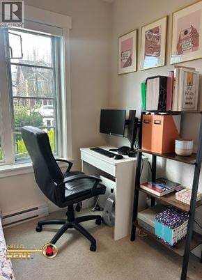 Vancouver townhouse for rent - A home office with a black chair, a desk with a computer monitor and keyboard, and a bookshelf with various items.