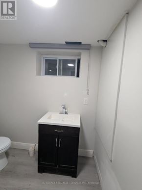 Niagara Falls (Dorchester) house for rent - A bathroom with a sink, toilet, and cabinet.