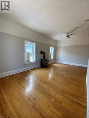 Paris apartment for rent - A room with wooden floors and a ceiling fan.