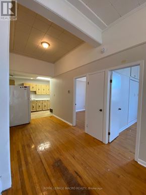 Brant (Paris) townhouse for rent - A room with wooden floors and white walls.